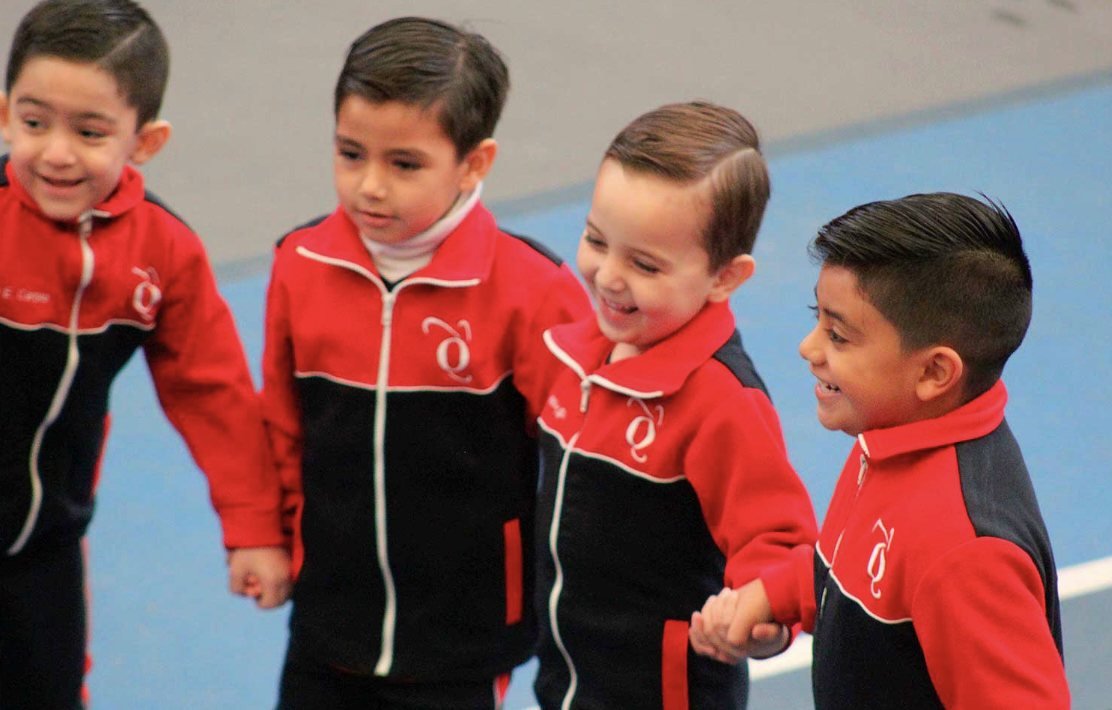 Young Oxfordian students walking hand in hand in their campus tracksuits