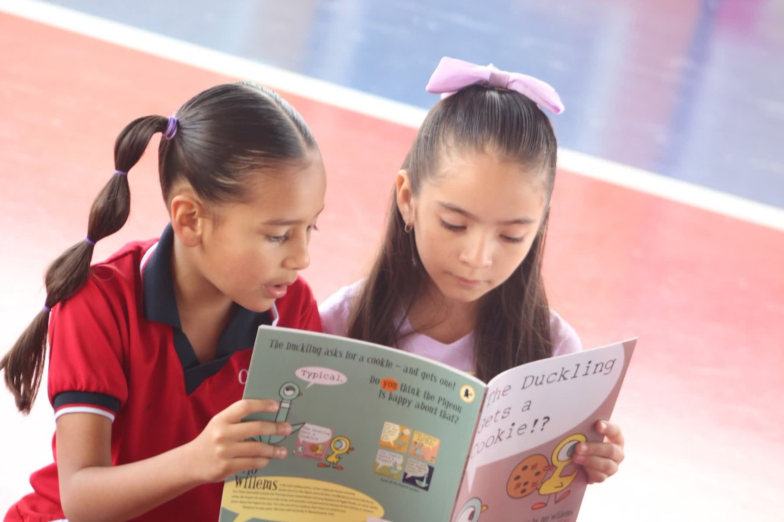 Two pupils reading a picture book together