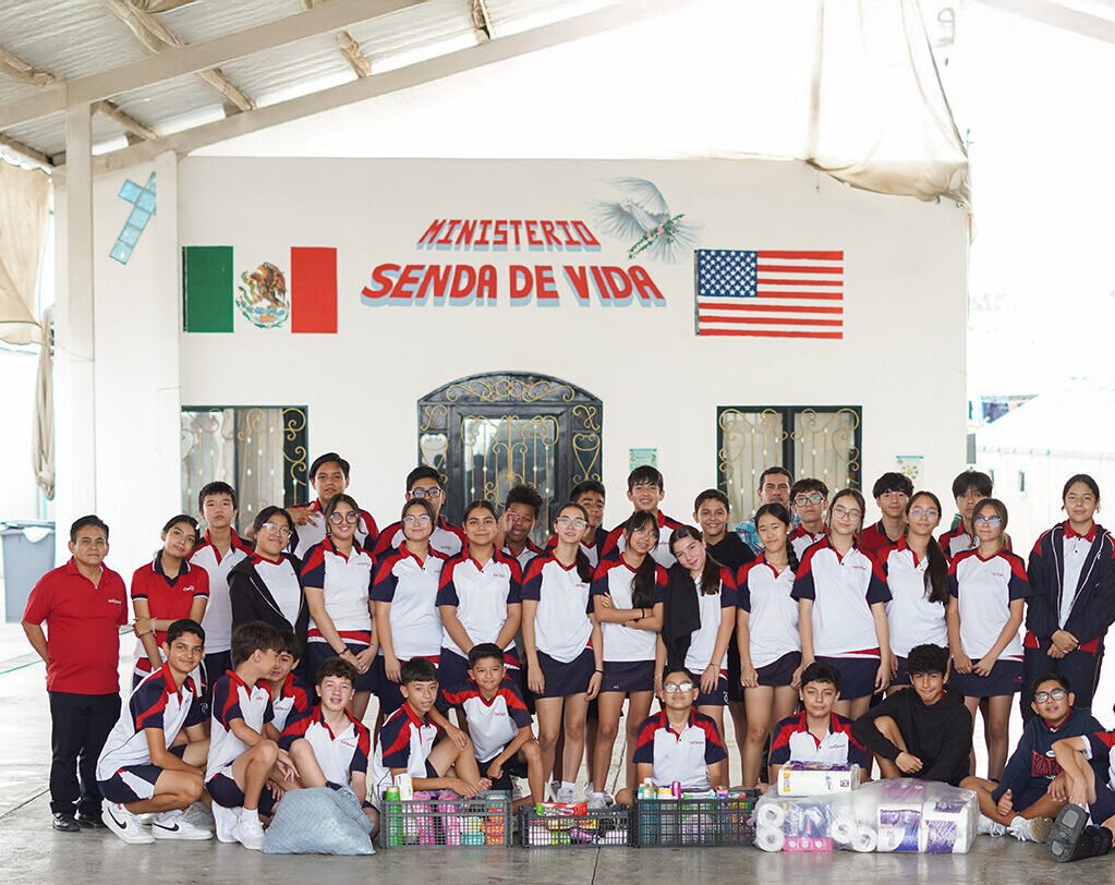 Oxfordian students with crates of donated supplies at Ministerio Senda de Vida