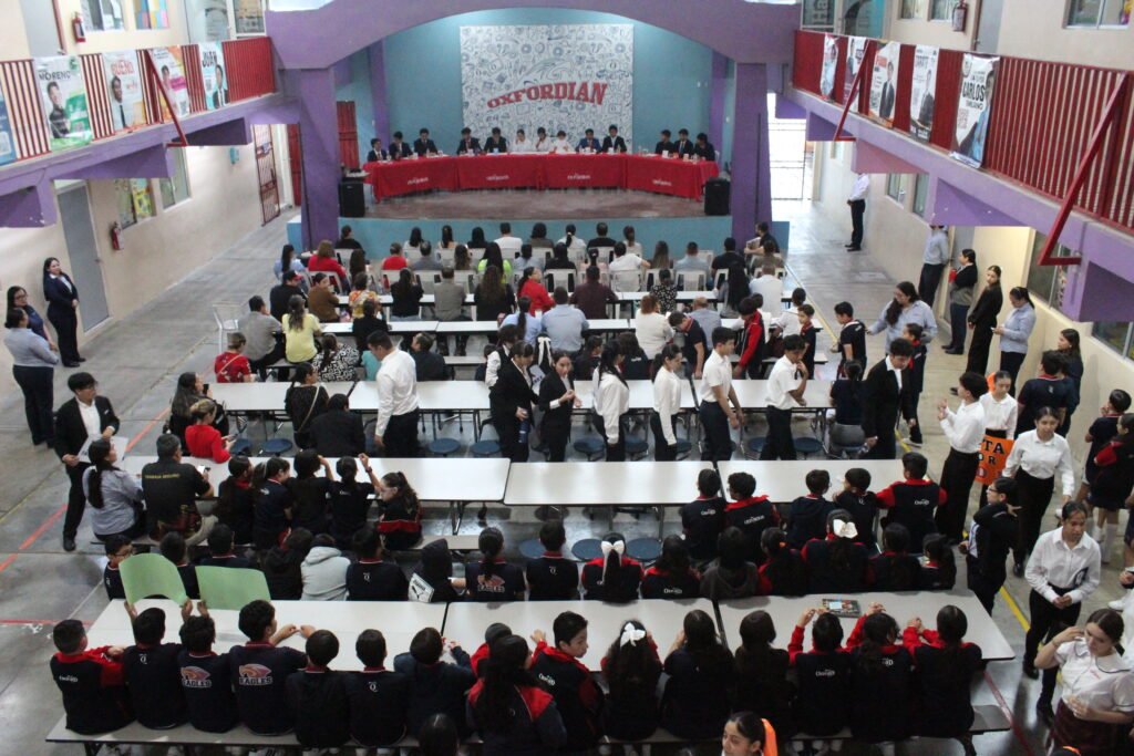 Students debating on stage in front of families and classmates