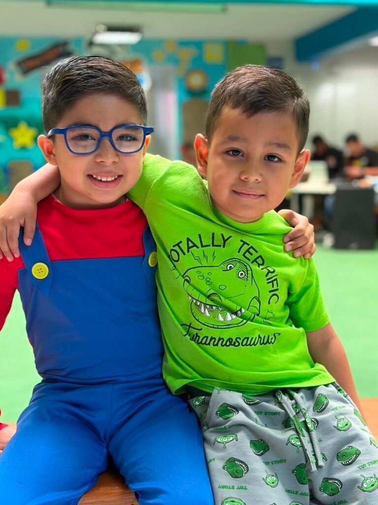 Two Petrolera pupils in costume at a school celebration
