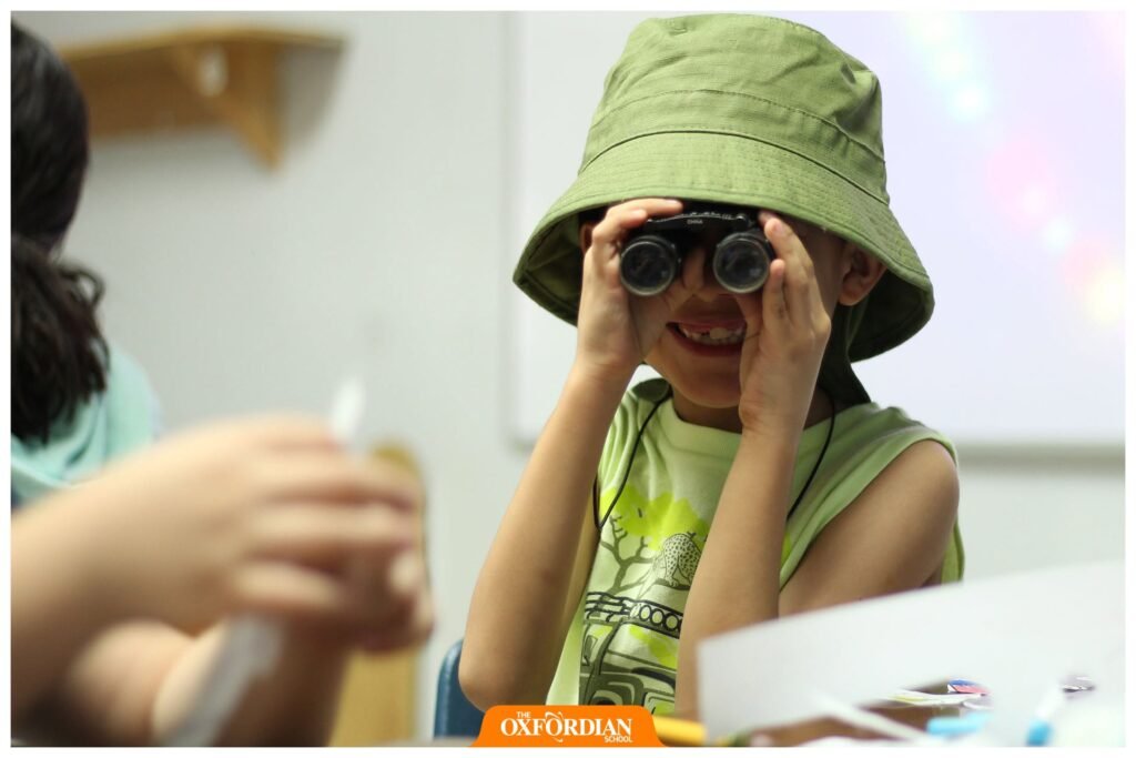 A Petrolera pupil exploring with binoculars