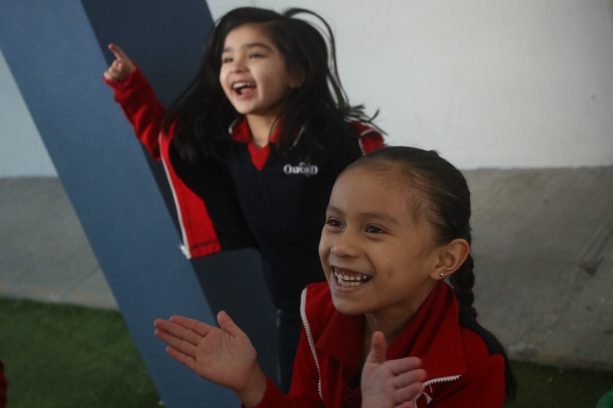 Two Las Fuentes pupils laughing and cheering