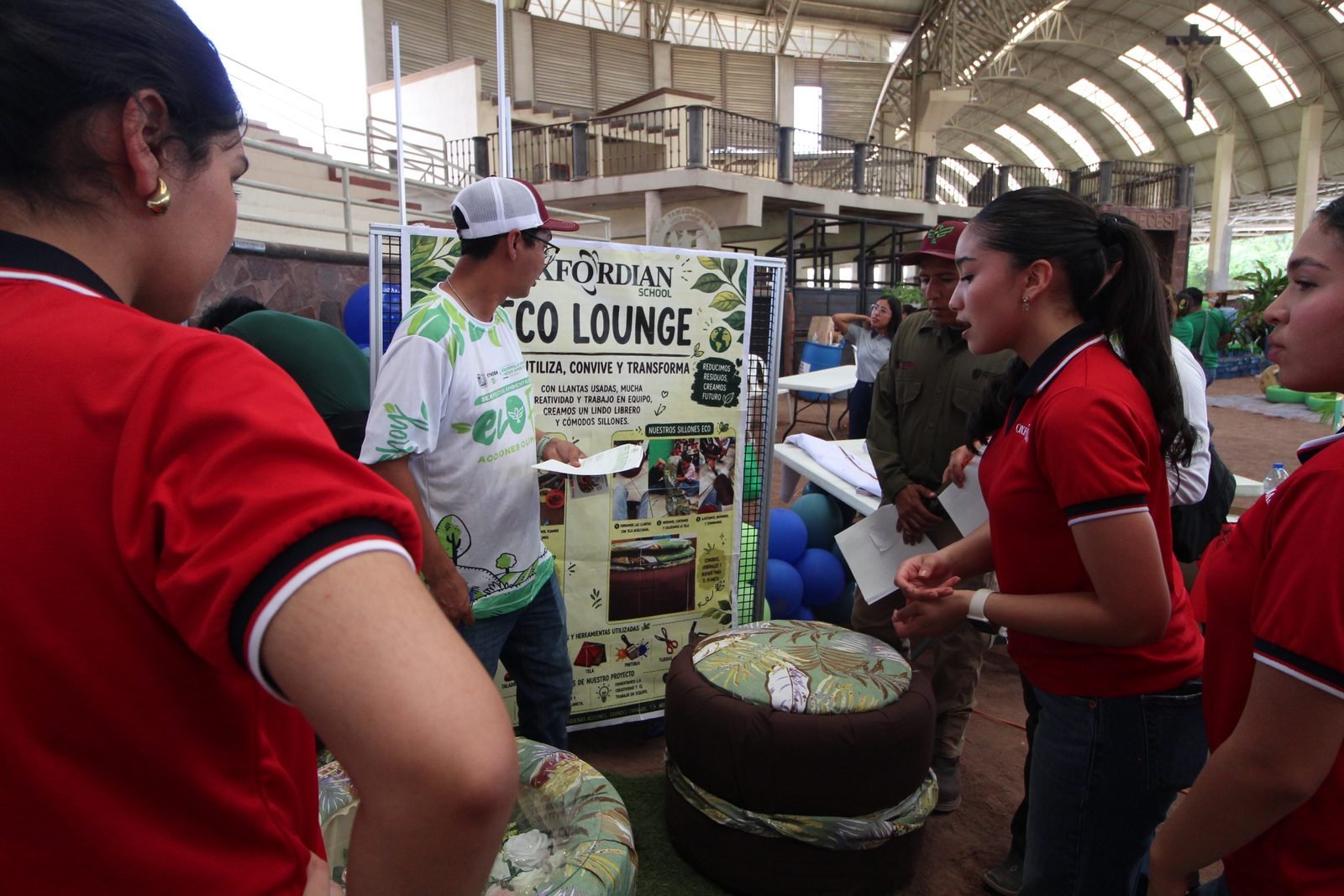 Oxfordian students presenting the Eco Lounge, seating made from used tyres, at an environmental fair