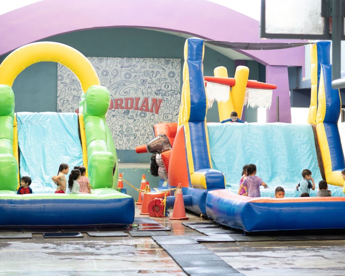 Children on inflatable water slides at the Vista Hermosa summer fun camp